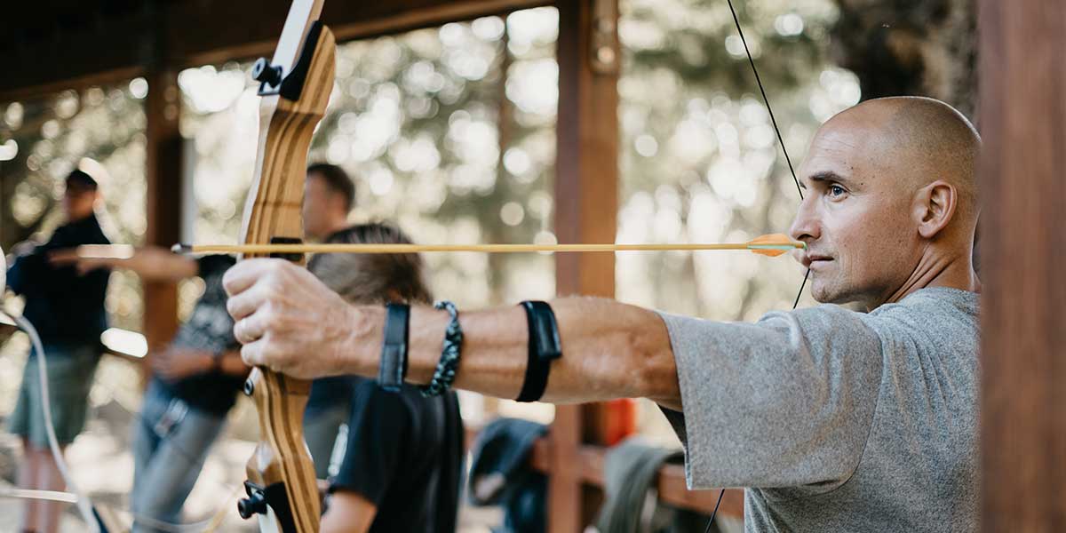 Man at range learning archery as a beginner